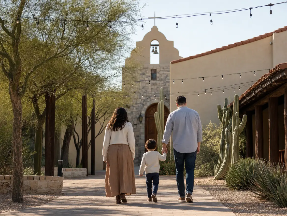 A parent and child seen from behind, walking hand in hand through the church courtyard